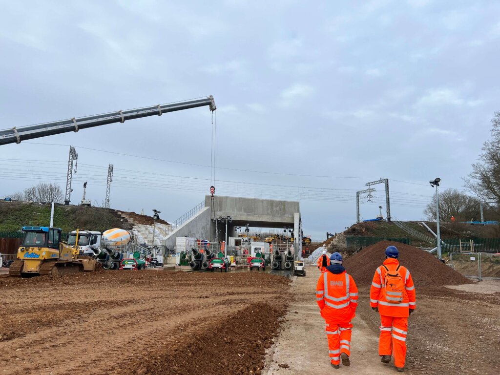 A view of the Jack Box at Radlett being installed with people in high-vis walking towards the site